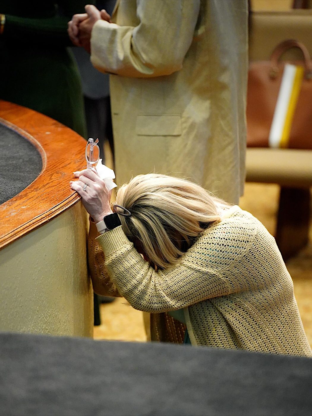 A woman praying at the altar