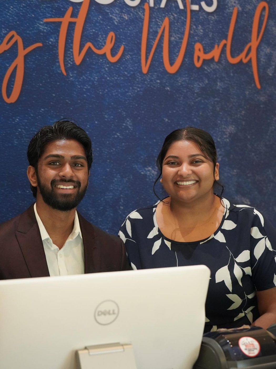 Two smiling volunteers at the welcome desk
