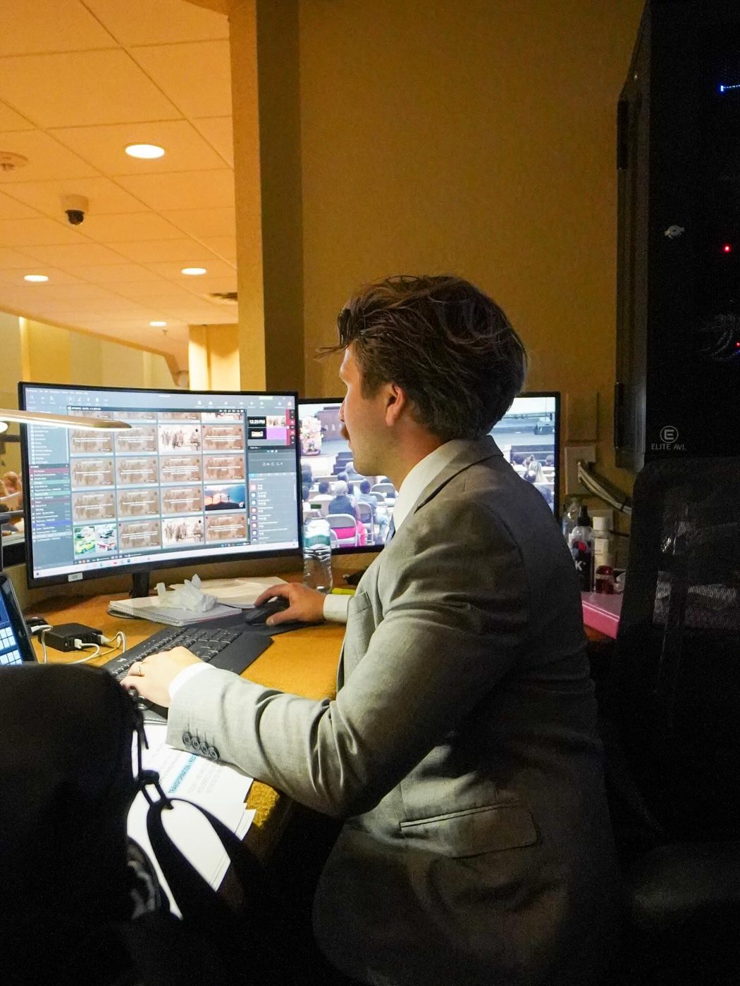 A volunteer at the production desk running the livestream