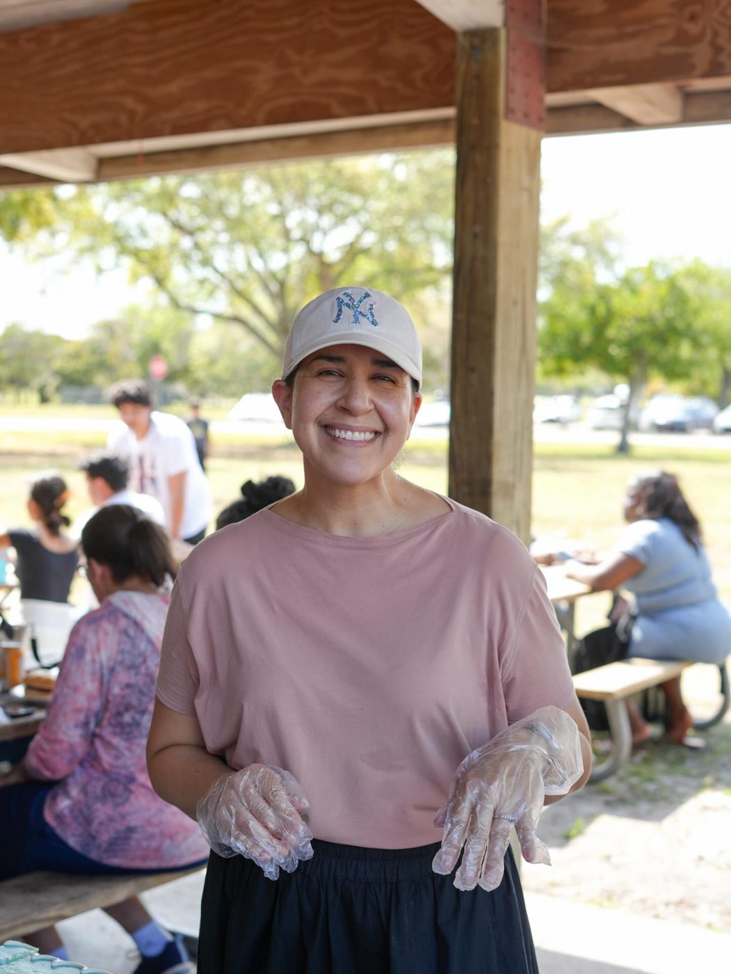 A smiling volunteer serving at the fellowship meal